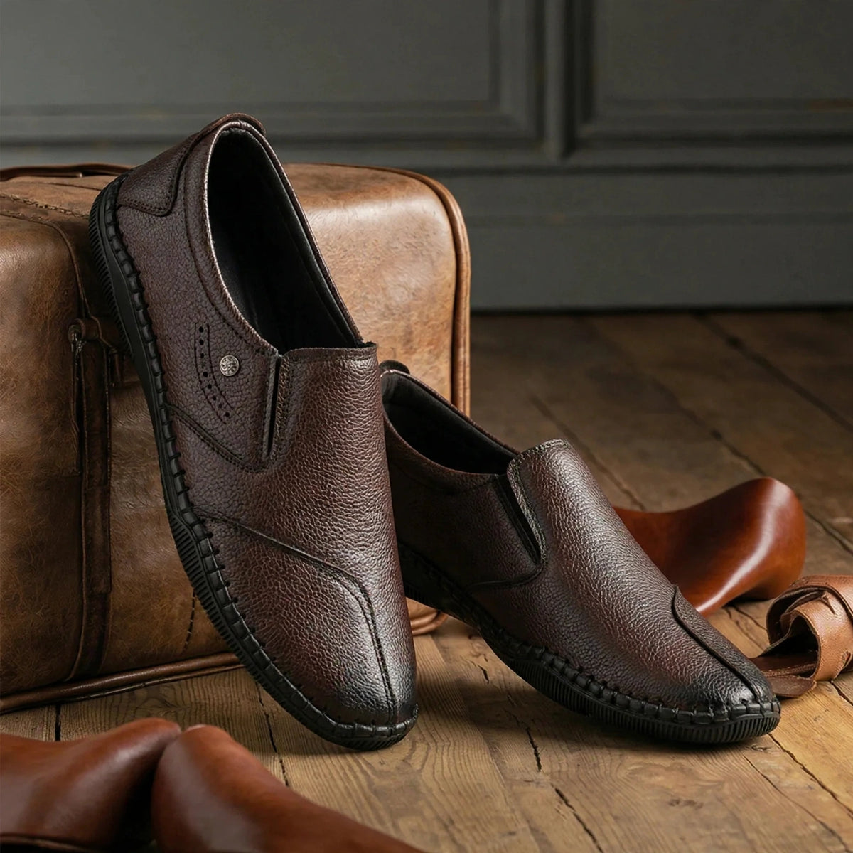 Men's brown synthetic leather slip-on shoes with round toe - inclined view