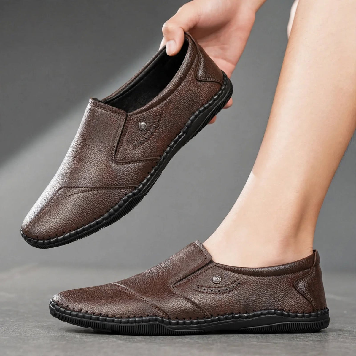 Men's brown synthetic leather slip-on shoes with round toe - side and angle view